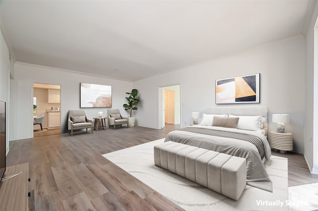 bedroom featuring ornamental molding and hardwood / wood-style flooring