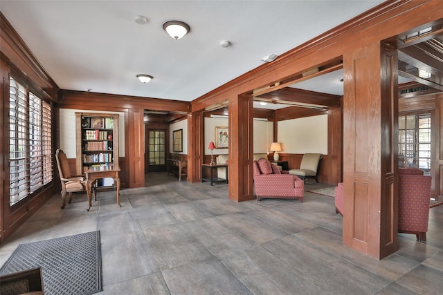 unfurnished room featuring ornamental molding and wood walls