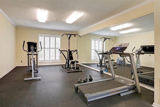 gym with a textured ceiling, a wealth of natural light, and ornamental molding