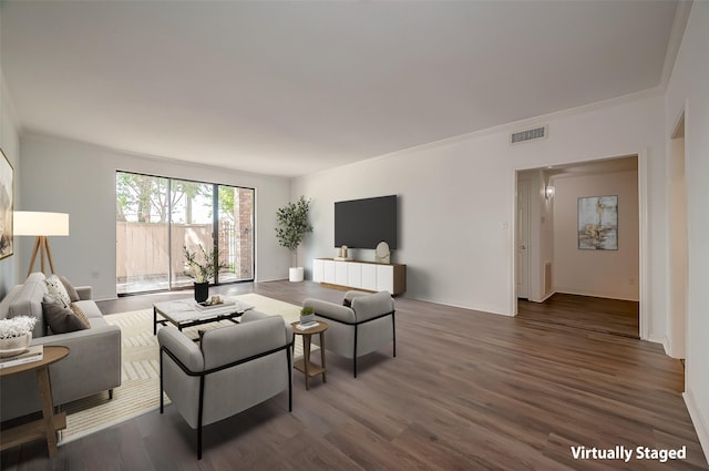 living room featuring wood finished floors, visible vents, and baseboards
