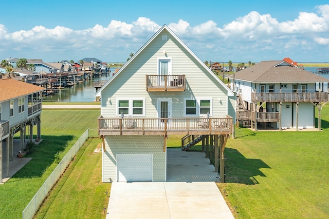 view of front of home with a water view, a garage, a balcony, and a front lawn