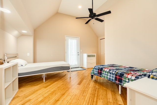 bedroom with ceiling fan, vaulted ceiling, and hardwood / wood-style floors