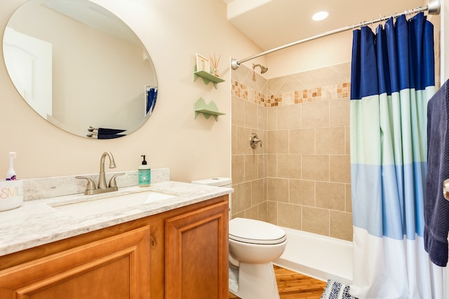 bathroom featuring vanity, toilet, a shower with shower curtain, and hardwood / wood-style flooring