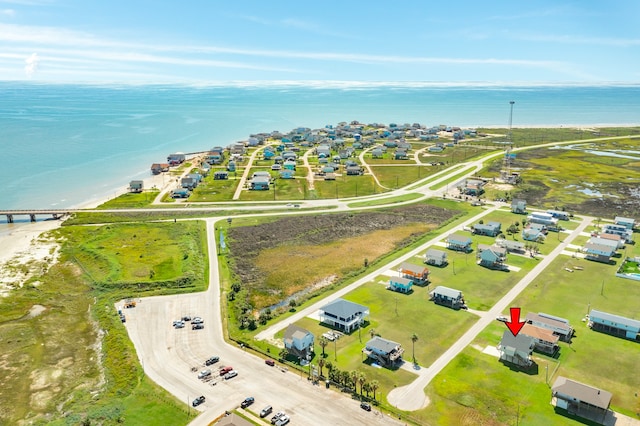 birds eye view of property featuring a water view and a beach view