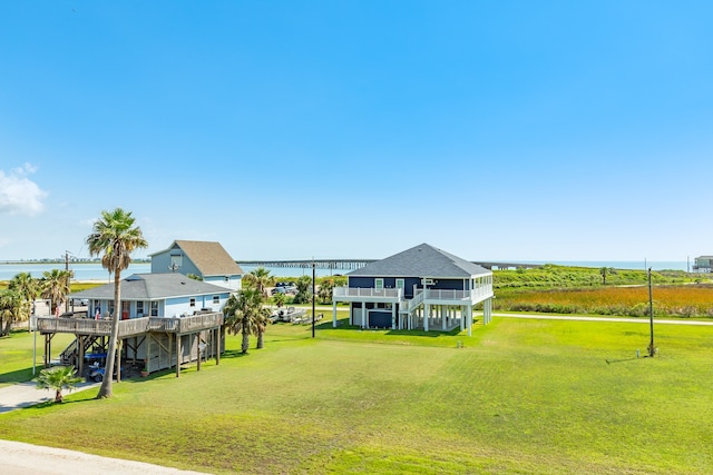 view of yard with a deck with water view