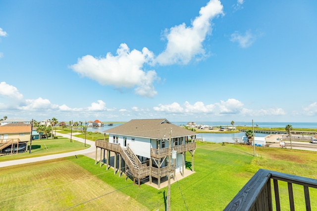 exterior space featuring a water view and a yard