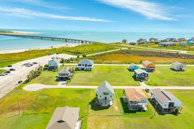 drone / aerial view with a water view and a view of the beach