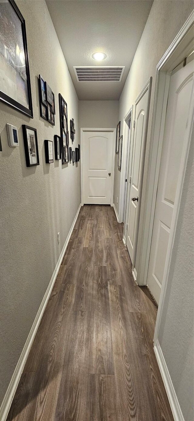 hallway featuring dark wood-type flooring