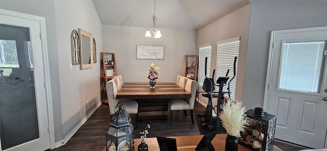 dining room featuring vaulted ceiling, dark wood-type flooring, and a chandelier