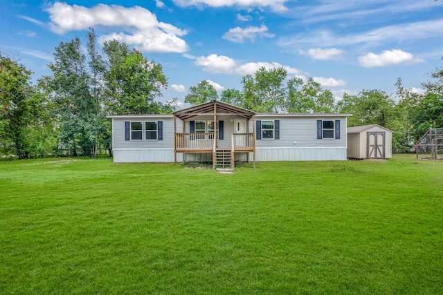 manufactured / mobile home with a storage shed, a wooden deck, and a front yard