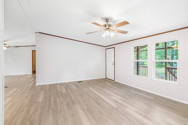 unfurnished room featuring crown molding, light hardwood / wood-style floors, lofted ceiling, and ceiling fan