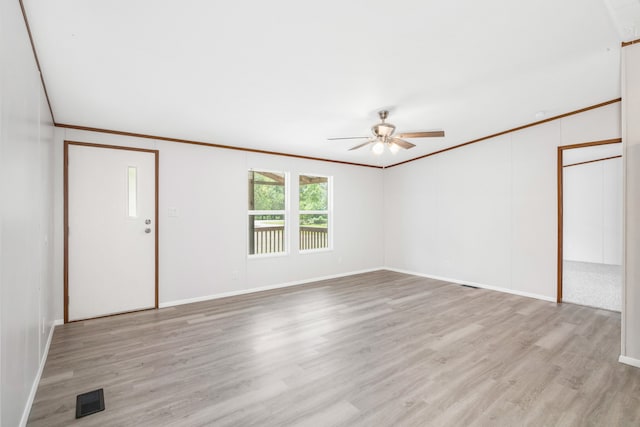 spare room with ceiling fan, crown molding, and light hardwood / wood-style floors