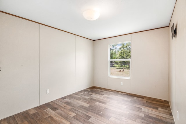 empty room featuring crown molding and hardwood / wood-style floors