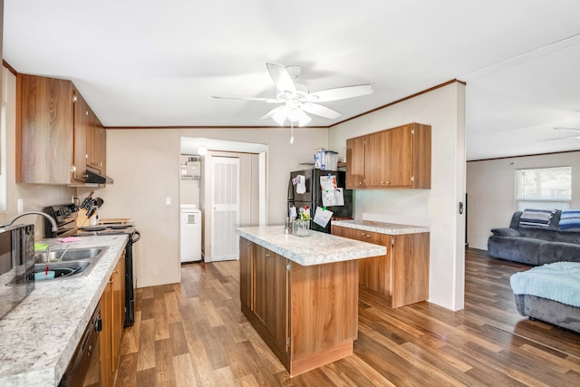 kitchen featuring ceiling fan, black fridge, hardwood / wood-style flooring, and a kitchen island