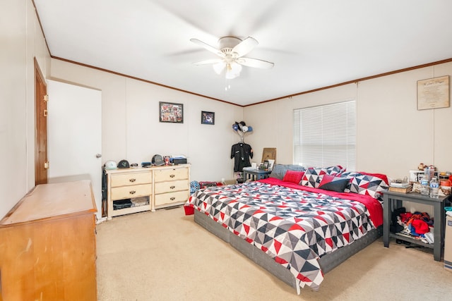 carpeted bedroom with ceiling fan and crown molding