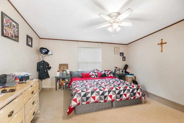 carpeted bedroom with ornamental molding and ceiling fan