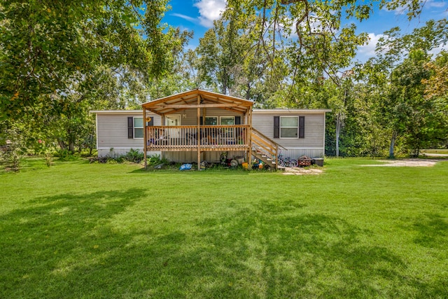 view of front of house with a front yard and a deck