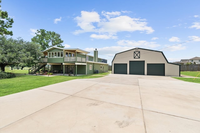 view of front of home with an outdoor structure, a garage, central AC unit, and a front yard