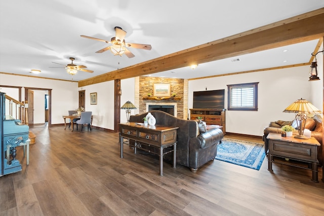 living room featuring a fireplace, ornamental molding, dark wood-type flooring, and ceiling fan