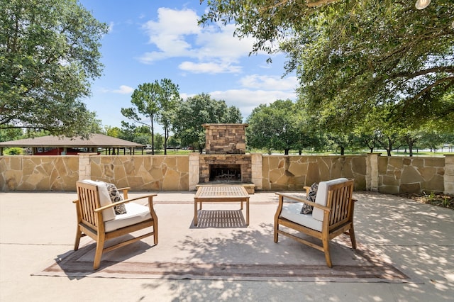 view of patio / terrace with an outdoor living space with a fireplace