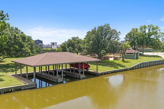 view of dock featuring a lawn and a water view