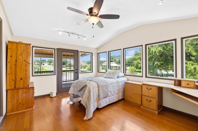 bedroom featuring multiple windows, access to outside, and ceiling fan