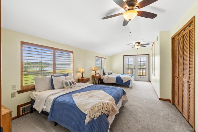 bedroom with ceiling fan, light colored carpet, vaulted ceiling, and multiple windows