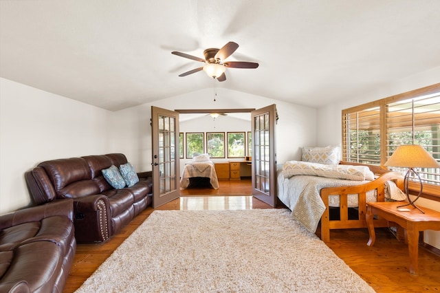 bedroom featuring french doors, lofted ceiling, wood-type flooring, and ceiling fan