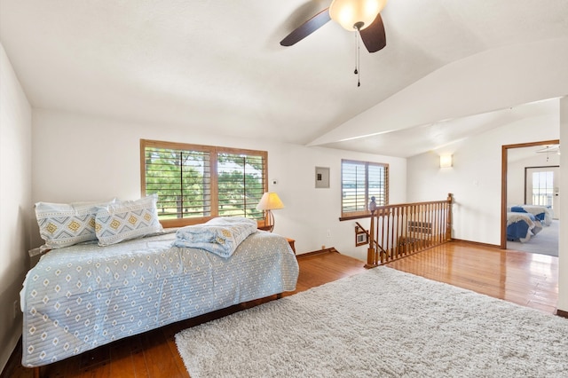 bedroom with lofted ceiling, hardwood / wood-style floors, and ceiling fan