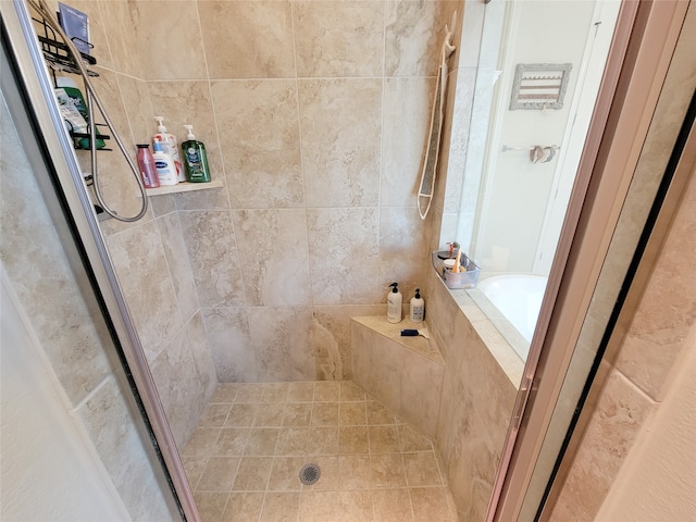 bathroom featuring shower with separate bathtub