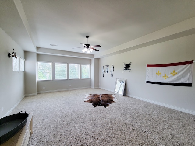 interior space featuring ceiling fan and carpet flooring