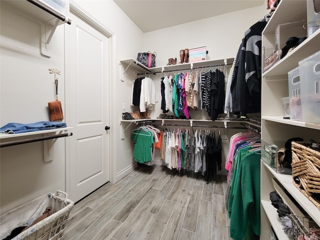 spacious closet with light hardwood / wood-style flooring