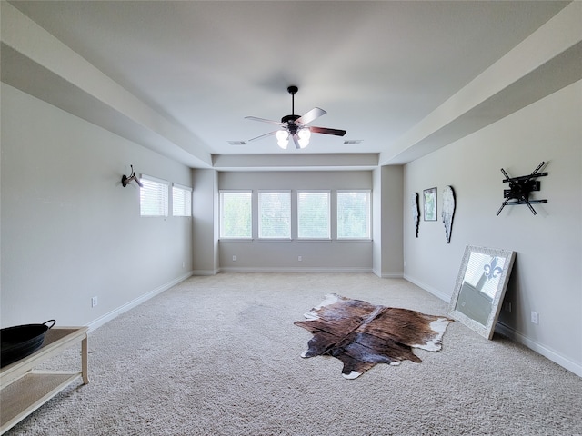 unfurnished living room featuring ceiling fan and light carpet