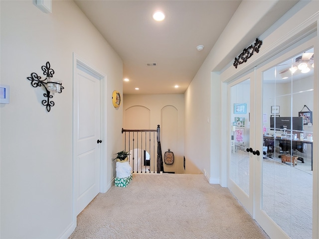 hallway with carpet flooring and french doors