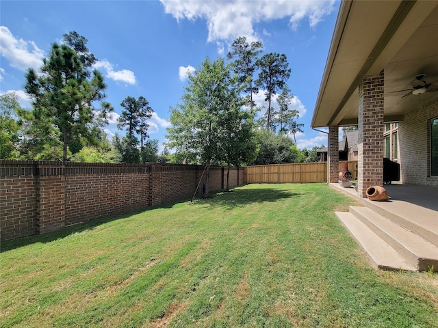 view of yard featuring ceiling fan and a patio area