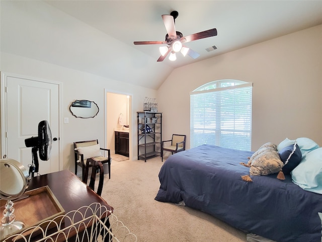 carpeted bedroom with connected bathroom, vaulted ceiling, and ceiling fan