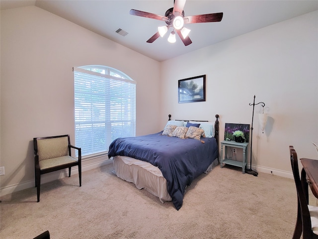 bedroom featuring light carpet, vaulted ceiling, and ceiling fan