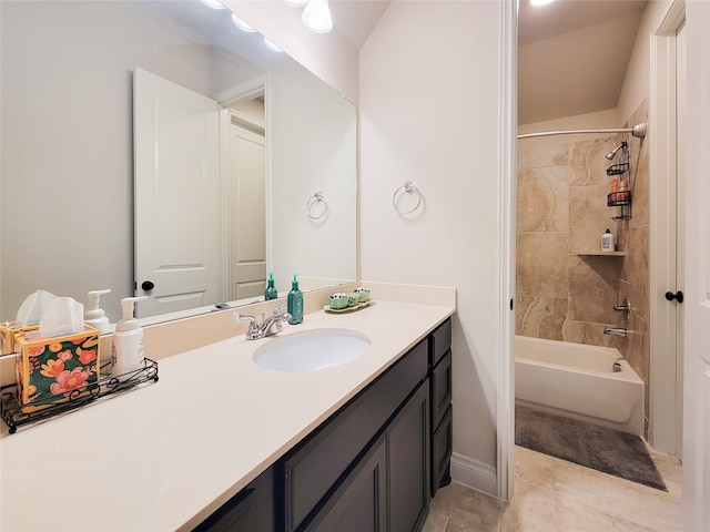 bathroom with lofted ceiling, vanity, tile patterned floors, and tiled shower / bath