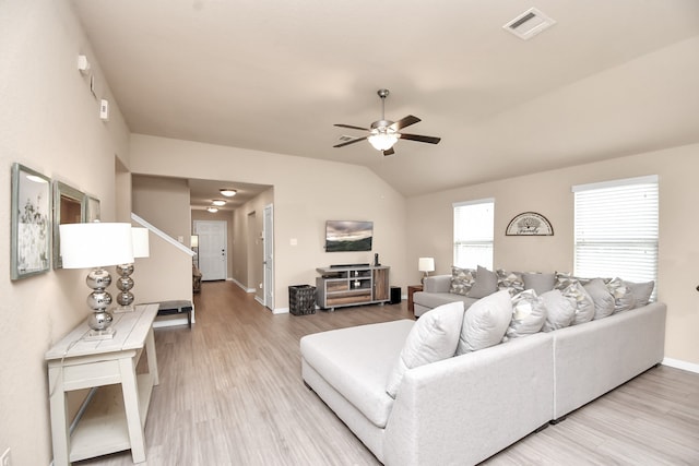 living room with light wood-type flooring, lofted ceiling, and ceiling fan