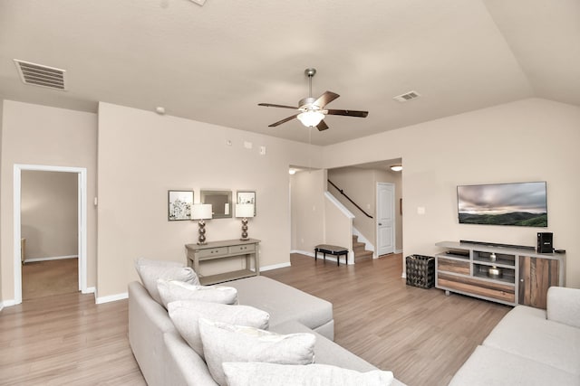 living room with light hardwood / wood-style floors, vaulted ceiling, and ceiling fan