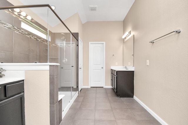 bathroom featuring tile patterned flooring, walk in shower, and vanity