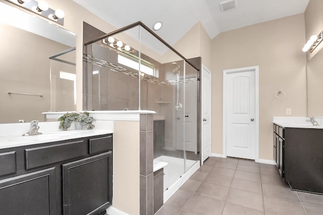 bathroom featuring vanity, tile patterned flooring, and a shower with shower door