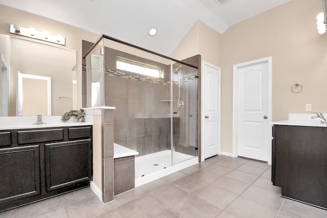 bathroom with vanity, lofted ceiling, tile patterned flooring, and a shower with door