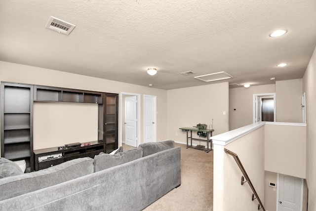 living room featuring light colored carpet and a textured ceiling