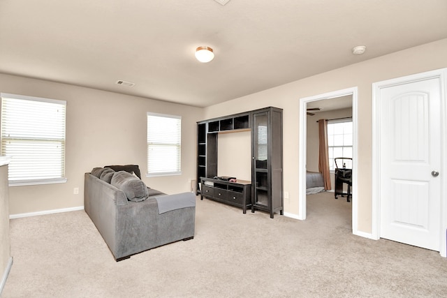 carpeted living room featuring a healthy amount of sunlight