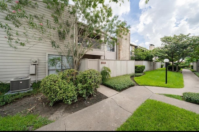 exterior space with a lawn and central air condition unit