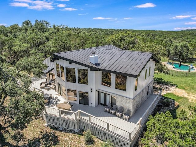 rear view of property with an outdoor hangout area and a wooden deck