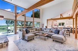 living room with beam ceiling and high vaulted ceiling