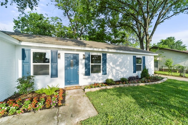 ranch-style home featuring a front yard