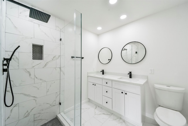 bathroom with tiled shower, vanity, and toilet